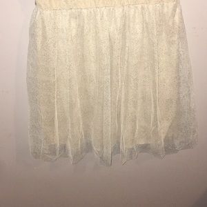 a cream dress with gold sparkles